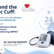 Professional minimal healthcare banner illustrating 24-hour Ambulatory Blood Pressure Monitoring (ABPM). A digital blood pressure monitor with cuff is placed beside a subtle 24-hour clock graphic, representing continuous blood pressure tracking throughout the day and night. The design features a clean white and blue medical theme with abstract healthcare elements, promoting awareness of ABPM in a modern clinical setting.